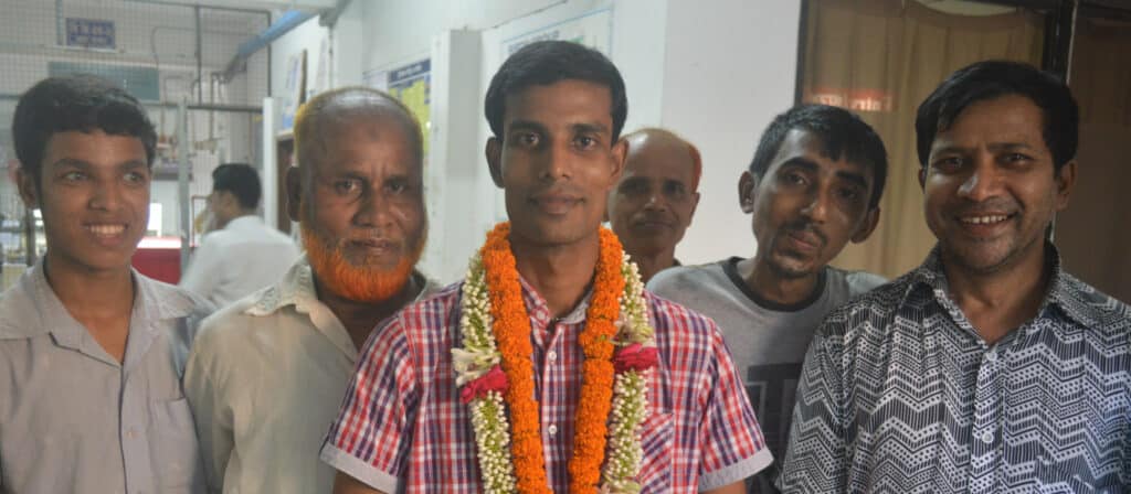 Rasel Rana (centre), one of the newly elected worker representatives, with supporters