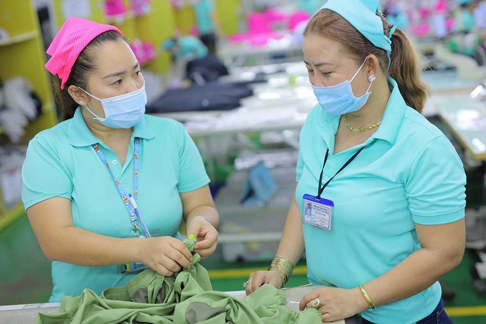 Thom (Pink hat) speaks with her worker about her work issues